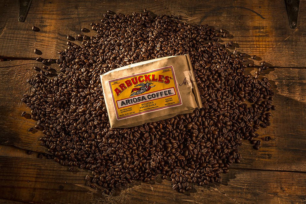 A bag of Arbuckles' Ariosa surrounded by roasted beans