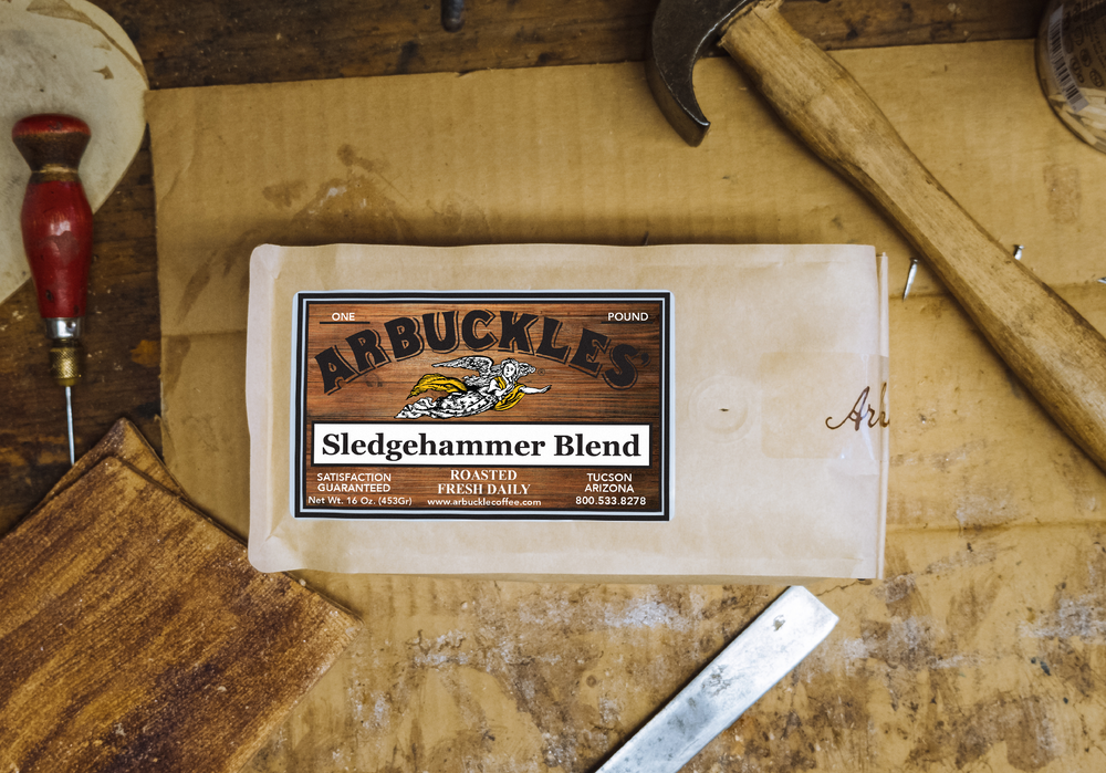 A bag of Arbuckles' Sledgehammer Blend on a workbench